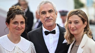 Italian director Alice Rohrwacher (L), Mexican film director Alfonso Cuaron (C) and Italian actress Alba Rohrwacher arrive for the Closing Ceremony of the 75th edition of the Cannes Film Festival in Cannes, southern France, on May 28, 2022. (Photo by LOIC VENANCE / AFP) (Photo by LOIC VENANCE/AFP via Getty Images)