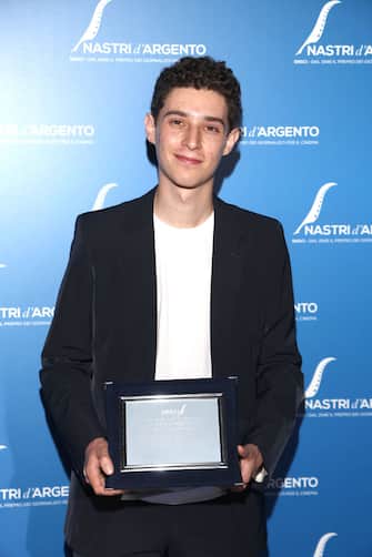 ROME, ITALY - JUNE 20: Filippo Scotti poses with his Guglielmo Biraghi Prize for â  The Hand Of Godâ   at the 76th Nastri D'Argento 2022 on June 20, 2022 in Rome, Italy. (Photo by Daniele Venturelli/Daniele Venturelli / WireImage  )