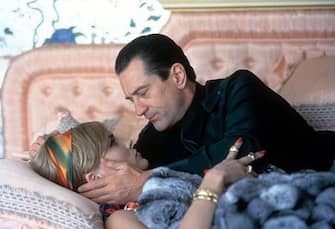 Robert De Niro and Sharon Stone having a tender moment as they lay on a bed in a scene from the film 'Casino', 1995. (Photo by Universal Pictures/Getty Images)