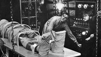 Colin Clive, as Dr. Frankenstein, and Dwight Frye, as his assistant Fritz, prepare to bring their monster to life in a scene from the 1931 movie version of Mary Shelley's Frankenstein.
