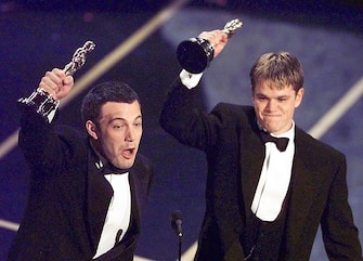 LOS ANGELES, UNITED STATES:  Ben Affleck (L) and Matt Damon hold up their Oscars after winning in the Original Screenplay  Category during the 70th Academy Awards at the Shrine Auditorium 23 March. The two won for their Original Screenplay "Good Will Hunting."    (ELECTRONIC IMAGE)   AFP PHOTO/Timothy A. Clary (Photo credit should read TIMOTHY A. CLARY/AFP via Getty Images)