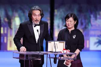 CANNES, FRANCE - MAY 27: Koji Yakusho (L) receives the Best Actor Award for 'Perfect Days' during the closing ceremony during the 76th annual Cannes film festival at Palais des Festivals on May 27, 2023 in Cannes, France. (Photo by Andreas Rentz/Getty Images)