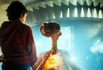 Henry Thomas talking with ET in a scene from the film 'E.T. The Extra-Terrestrial', 1982. (Photo by Universal/Getty Images)