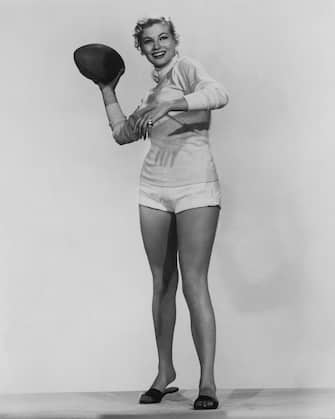Swedish-born Italian actress Anita Ekberg (1931 - 2015) throwing a football, circa 1955. (Photo by Phil Burchman/Archive Photos/Getty Images)