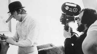 (Original Caption) Director Stanley Kubrick (right) filming close-up of little Alex in his phallic mask cutting the clothes off a woman he is about to rape in the picture A Clockwork Orange. The film won the 1971 best film honors of the New York film critics.