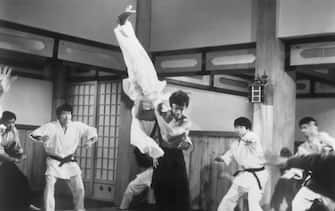 (Original Caption) Picture shows actor, Bruce Lee, taking on the entire membership of a Japanese boxing club from the movie "The Chinese Connection'. filed 5/27/73.