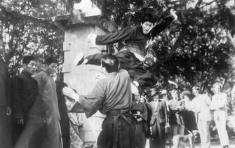 (Original Caption) Bruce Lee demonstrates a Kung-fu kick for the benefit of visitors to the set of "The Chinese Connection". Undated photo.
