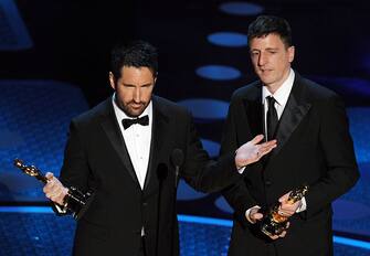 Composers Atticus Ross (R) and Trent Reznor, winners of the award for Best Original Score for 'The Social Network' accept their award on stage at the 83rd Annual Academy Awards held at the Kodak Theatre on February 27th, 2011 in Hollywood, California. AFP PHOTO / GABRIEL BOUYS (Photo credit should read GABRIEL BOUYS/AFP via Getty Images)