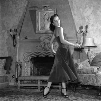 British-born actress Elizabeth Taylor wearing a velvet evening dress and high-heeled shoes, circa 1950. (Photo by Archive Photos/Getty Images)