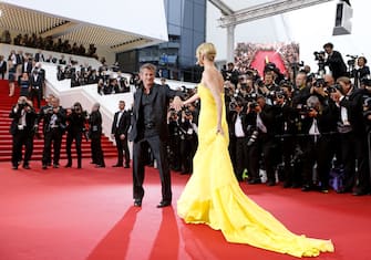 South African-US actress Charlize Theron (R) and her partner US actor Sean Penn pose as they arrive for the screening of the film "Mad Max : Fury Road" during the 68th Cannes Film Festival in Cannes, southeastern France, on May 14, 2015.       AFP PHOTO / VALERY HACHE / AFP / VALERY HACHE        (Photo credit should read VALERY HACHE/AFP via Getty Images)