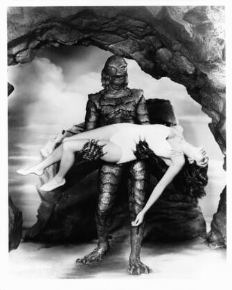 Julie Adams is carried by the creature in publicity portrait for the film 'Creature From The Black Lagoon', 1954. (Photo by Universal-International/Getty Images)