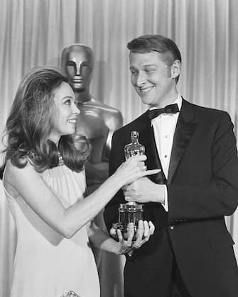 (Original Caption) 4/12/1968-Santa Monica, CA: Lovely Leslie Caron presents Mike Nichols with an Oscar for Best Director at the 40th Annual Academy Awards presentation here, April 10th. Nichols got the award for his highly acclaimed film, "The Graduate."