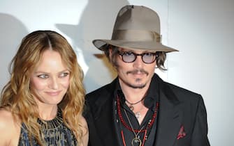 French actress Vanessa Paradis (L) and her husband, US actor Johnny Depp (R) arrive to attend the Figaro Madame/Chanel dinner during the 63rd Cannes Film Festival on May 18, 2010 in Cannes. AFP PHOTO / MARTIN BUREAU (Photo credit should read MARTIN BUREAU/AFP via Getty Images)