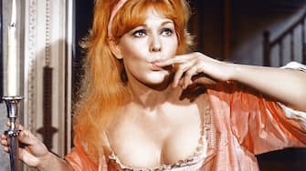 Kim Novak, US actress, with long red hair and her finger in her mouth in a publicity still isuued for the film, 'The Amorous Adventures of Moll Flanders', United Kingdom, 1965. The adaptation of the novel by Daniel Defoe (1660 1731, diirected by Terence Young (1915 1994), starred Novak as 'Moll Flanders'. (Photo by Silver Screen Collection/Getty Images)