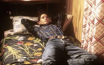 Hilary Swank distesa su un letto durante una scena del film Boys don’t cry del 1999
