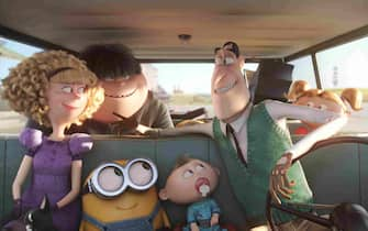 "Minions" (2015) BOB (center) hitches a ride to Villain-Con from the Nelson family—(L to R) Madge (ALLISON JANNEY), Walter Jr. (MICHAEL BEATTIE), Binky, Walter (MICHAEL KEATON) and Tina (KATY MIXON)—in "Minions", Universal Pictures and Illumination Entertainment's comedy adventure in which the Minions try to save all Minionkind...from annihilation.