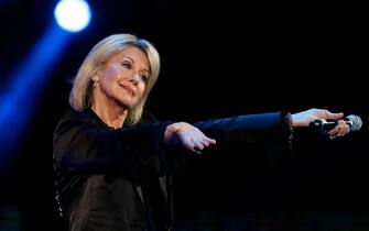 (FILES) In this file photo taken on February 23, 2017 British-Australian singer Olivia Newton-John performs at the 58th Vina del Mar International Song Festival in Vina del Mar, Chile. - Australian singer Olivia Newton-John, who gained worldwide fame as high-school sweetheart Sandy in the hit musical movie "Grease," died on August 8, 2022, her family said. She was 73. The entertainer, whose career spanned more than five decades, devoted much of her time and celebrity to charities after being diagnosed with breast cancer in 1992. (Photo by PAUL PLAZA / AFP)
