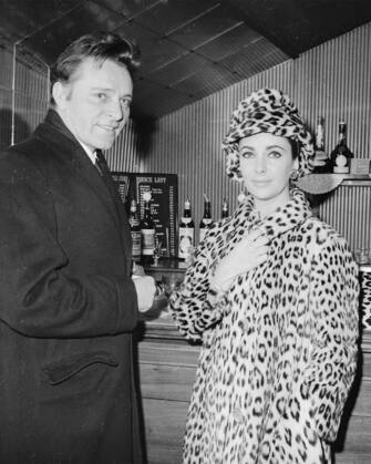 21st February 1963:  Celebrity couple Richard Burton (1825 - 1984) and Elizabeth Taylor standing at the bar of the Saville Theatre, London.  (Photo by Kaye/Express/Getty Images)