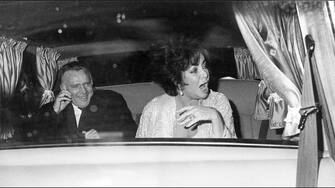 Richard Burton and Elizabeth Taylor in a car on her 50th birthday. (Photo by Michael Ward/Getty Images)