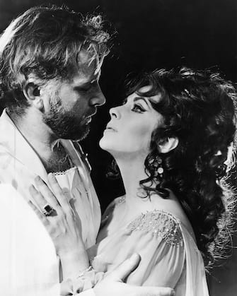 Welsh actor Richard Burton (1925 - 1984) and his wife, actress Elizabeth Taylor (1932 - 2011) in costume as 'Dr Faustus' and Helen of Troy in an Oxford University Dramatic Society production of the play by Christopher Marlowe at the Oxford Playhouse, 14th February 1966. Burton and Taylor are not being paid for their performances, and the proceeds will go to the university's theatre workshop fund. (Photo by Angus McBean/Central Press/Hulton Archive/Getty Images)