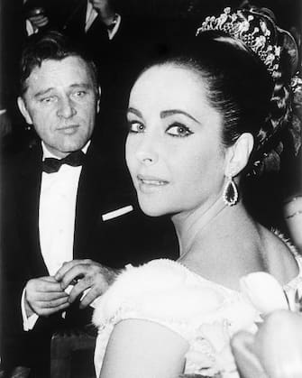 (Original Caption) 3/15/1963-Paris, France: Elizabeth Taylor and Richard Burton attend the benefit premiere of the film "Lawrence of Arabia," here 3/15. The pair co-star in the film "Cleopatra."