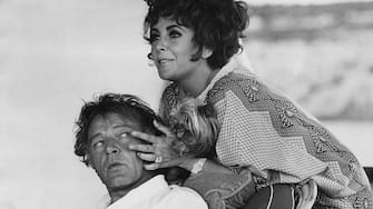British-born actress Elizabeth Taylor and her husband, Welsh actor Richard Burton (1925 - 1984) on their yacht 'Kalizma' off Capo Caccia on the coast of Sardinia, August 1967. They are both there for the location filming of 'Boom' by Tennessee Williams. (Photo by Express/Hulton Archive/Getty Images)