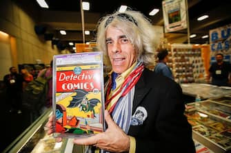 SAN DIEGO, CA - JULY 26:  Michael Carbonaro of D&A Cardworld poses with Detective Comics #27 at Comic-Con International at San Diego Convention Center on July 26, 2014 in San Diego, California.  The May 1939 issue marks the first appearance of the Batman character and is valued at approximately $550,000.  (Photo by Daniel Knighton/WireImage)