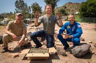 484422300 LA CANADA FLINTRIDGE, CA - AUGUST 18: In this handout provided by the National Aeronautics and Space Administration (NASA), Actor Matt Damon, who stars as NASA Astronaut Mark Watney in the film "The Martian," smiles after having made his hand prints in cement at the Jet Propulsion Laboratory (JPL) Mars Yard, while Mars Science Lab Project Manager Jim Erickson, left, and NASA Astronaut Drew Feustel look on, August 18, 2015, at the United Artist Theater in La Canada Flintridge, California. NASA scientists and engineers served as technical consultants on the film. The movie portrays a realistic view of the climate and topography of Mars, based on NASA data, and some of the challenges NASA faces as we prepare for human exploration of the Red Planet in the 2030s. (Photo by Bill Ingalls/NASA via Getty Images)