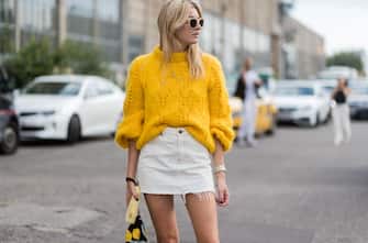 COPENHAGEN, DENMARK - AUGUST 10: Camille Charriere wearing a yellow knit, mini skirt outside Ganni on August 10, 2017 in Copenhagen, Denmark. (Photo by Christian Vierig/Getty Images)