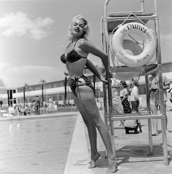 American film actor and sex symbol Jayne Mansfield (1933 - 1967) poses in a bikini by a lifeguard chair at the Dunes Hotel, Las Vegas, Nevada, mid 1950's. (Photo by Hulton Archive/Getty Images)