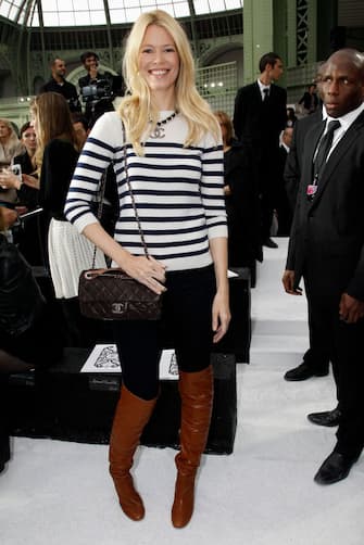 104791090 PARIS - OCTOBER 05: Claudia Schiffer attends the Chanel Ready to Wear Spring/Summer 2011 show during Paris Fashion Week at Grand Palais on October 5, 2010 in Paris, France. (Photo by Michel Dufour/WireImage)
