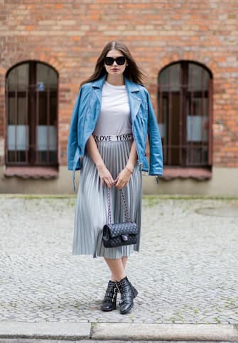 BERLIN, GERMANY - JUNE 30: Maxilie Mlinarskij wearing a silver midi skirt Mango, a white tshirt H&M, a blue leather jacket Be Edgy, black Topshop boots, black Chanel bag, Zero Vintage sunglasses on June 30, 2017 in Berlin, Germany. (Photo by Christian Vierig/Getty Images)