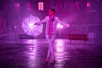 PARIS, FRANCE - AUGUST 02: A visitor dances at the 'Purple Rain' installation at the LycÃ©e Jacques-Decour on August 02, 2020 in Paris, France. Part of Festival Paris l'EtÃ©, the installation by Pierre Ardouvin is a tribute to the song by Prince and allows visitors to role play while equipped with umbrellas and accompanied by the song. (Photo by Kiran Ridley/Getty Images)