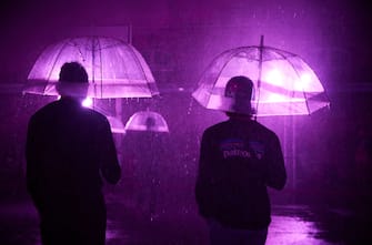PARIS, FRANCE - AUGUST 02: Visitors stand with umbrellas at the 'Purple Rain' installation at the LycÃ©e Jacques-Decour on August 02, 2020 in Paris, France. Part of Festival Paris l'EtÃ©, the installation by Pierre Ardouvin is a tribute to the song by Prince and allows visitors to role play while equipped with umbrellas and accompanied by the song. (Photo by Kiran Ridley/Getty Images)