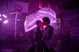PARIS, FRANCE - AUGUST 02: A couple share a kiss at the 'Purple Rain' installation at the LycÃ©e Jacques-Decour on August 02, 2020 in Paris, France. Part of Festival Paris l'EtÃ©, the installation by Pierre Ardouvin is a tribute to the song by Prince and allows visitors to role play while equipped with umbrellas and accompanied by the song. (Photo by Kiran Ridley/Getty Images)