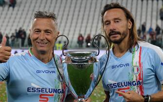 1146666576 TURIN, ITALY - MAY 27: Paolo Belli (l) and Bob Sinclar (r) of Nazionale Italiana Cantanti with the trophy during the 'Partita Del Cuore' Charity Match at Allianz Stadium on May 27, 2019 in Turin, Italy. (Photo by Chris Ricco/Getty Images)