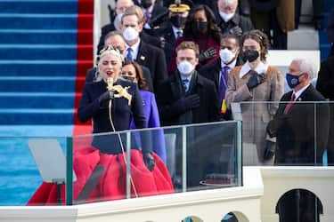 WASHINGTON, DC - JANUARY 20: Lady Gaga sings the National Anthem at the inauguration of U.S. President-elect Joe Biden on the West Front of the U.S. Capitol on January 20, 2021 in Washington, DC.  During today's inauguration ceremony Joe Biden becomes the 46th president of the United States. (Photo by Rob Carr/Getty Images)