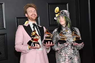 LOS ANGELES, CALIFORNIA - MARCH 14: (L-R) FINNEAS and Billie Eilish, winners of Record of the Year for 'Everything I Wanted' and Best Song Written For Visual Media for "No Time To Die", pose in the media room during the 63rd Annual GRAMMY Awards at Los Angeles Convention Center on March 14, 2021 in Los Angeles, California. (Photo by Kevin Mazur/Getty Images for The Recording Academy )