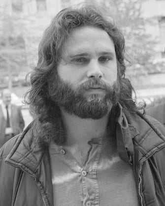 (Original Caption) Jim Morrison (L), lead singer of the rock group "The Doors" is accompanied by his attorney Max Fink as he arrives at the Los Angeles Federal Building to appear before the U.S. Commissioner for extradition proceedings to Florida. Morrison, according to the FBI, was wanted on six charges, including lewd and lascivious behavior, while performing before some 12,000 persons, mostly teen-agers. The FBI said they entered the case 3/27 when a federal warrant charging interstate flight to avoid prosecution was issued in Miami.