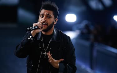 PARIS, FRANCE - NOVEMBER 30:  The Weeknd performs on the runway during the 2016 Victoria's Secret Fashion Show at the Grand Palais in Paris on November 30, 2016 in Paris, France.  (Photo by Thomas Concordia/FilmMagic)