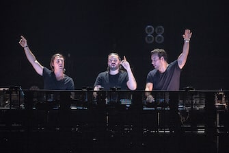 PARIS, FRANCE - DECEMBER 08: (L-R) Axwell, Steve Angello and Sebastian Ingrosso from Swedish House Mafia perform at Palais Omnisports de Bercy on December 8, 2012 in Paris, France. (Photo by David Wolff - Patrick/Redferns via Getty Images)