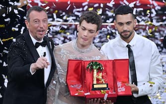 Sanremo Festival host and artistic director, Amadeus (L) with Italian singers Blanco & Mahmoodon pose on stage at the Ariston theater with the prize after winning the 72nd Sanremo Italian Song Festival, in Sanremo, Italy, 05 February 2022. The music festival runs from 01 to 05 February 2022. ANSA / ETTORE FERRARI
 