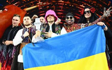 Members of the band "Kalush Orchestra" pose onstage with the winner's trophy and Ukraine's flags after winning on behalf of Ukraine the Eurovision Song contest 2022 on May 14, 2022 at the Pala Alpitour venue in Turin. (Photo by Marco BERTORELLO / AFP) (Photo by MARCO BERTORELLO/AFP via Getty Images)