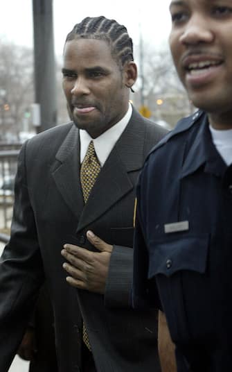 CHICAGO - DECEMBER 20: (FILE PHOTO) Embattled R and B singer R. Kelly (L) heads to court December 20, 2002 in Chicago, Illinois.  R. Kelly was arrested on a warrant alleging 12 counts of possession of child pornography January 22, 2003 in Miami, Florida.  (Photo by Scott Olson / Getty Images)