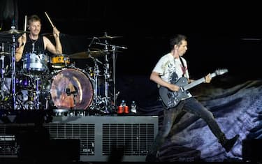 05 June 2022, Bavaria, Nuremberg: Frontman Matthew Bellamy (r) performs with the British rock band Muse at the open-air "Rock im Park" festival. It is one of the biggest music festivals in Bavaria. After a two-year break from the festival, around 75,000 music fans celebrated exuberantly at "Rock im Park". Photo: Daniel Karmann/dpa (Photo by Daniel Karmann/picture alliance via Getty Images)
