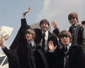 2nd July 1964: The Beatles (from left to right, John Lennon (1940 - 1980), George Harrison (1943 - 2001), Paul McCartney and Ringo Starr) arrive back at London Airport after their Australian tour.  (Photo by Fox Photos / Getty Images)