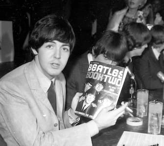 LOS ANGELES - AUGUST 23: Paul McCartney of the rock and roll band "The Beatles" poses for a portrait during a press conference holding a fanzine entitled "The Beatles Book Two" backstage at their concert at the Hollywood Bowl on August 23, 1964 in Los Angeles, California.  (Photo by Michael Ochs Archives / Getty Images)