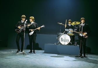 From left, George Harrison (playing a Gretsch 6119 Tennessean guitar with Bigsby vibrato), John Lennon (playing a Rickenbacker 325 guitar), Ringo Starr (playing Ludwig drum kit) and Paul McCartney (playing a Hofner 500/1 violin bass guitar) of English rock and pop group The Beatles perform together on stage for the American Broadcasting Company (ABC) music television show 'Shindig!' at Granville Studios in Fulham, London on 3rd October 1964. The band would play three songs on the show, Kansas City/hey-Hey-Hey!, I'm a Loser and Boys. (Photo by David Redfern/Redferns)