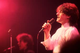 Irish Rock musician Bono (born Paul Hewson), of the group U2, performs onstage at Park West, Chicago, Illinois, April 12, 1981. Visible in the background is bandmate the Edge (born David Evans). (Photo by Paul Natkin/Getty Images)