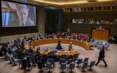 Permanent Representative of Ukraine to the UN, Sergiy Kyslytsya, takes his seat as British musician Roger Waters is displayed on a screen prior to a UN Security Council meeting on Ukraine, at UN headquarters in New York on February 8, 2023. (Photo by Ed JONES / AFP) (Photo by ED JONES/AFP via Getty Images)